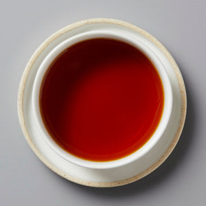 Top view of a cup filled with golden bud black tea, Tree Sap 2024, from Lincang, Yunnan, China.
