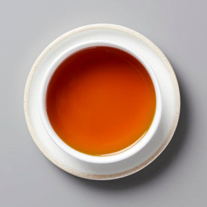 2020 BRUISER black tea in white ceramic cup showing rich amber-colored liquor from above
