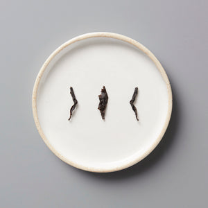 Zi Ran Red black tea leaves artfully arranged on white ceramic plate showing natural twisted leaf form and quality