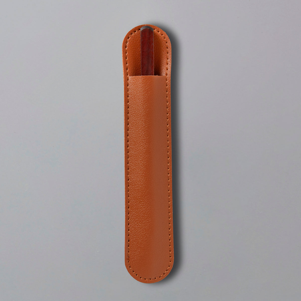 Tea Knife Hugo in brown leather protective sheath with stitched edges against gray background