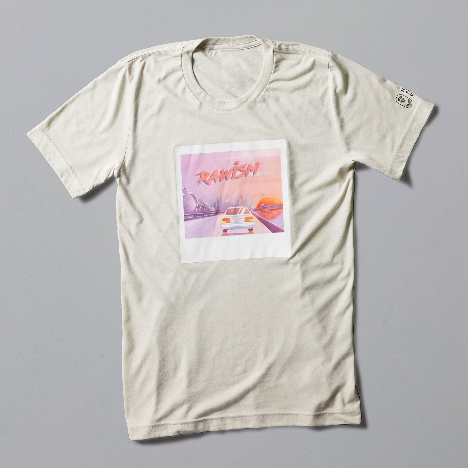 RAWISM Tee in off-white featuring retro sunset artwork with car illustration in pastel pink and orange tones