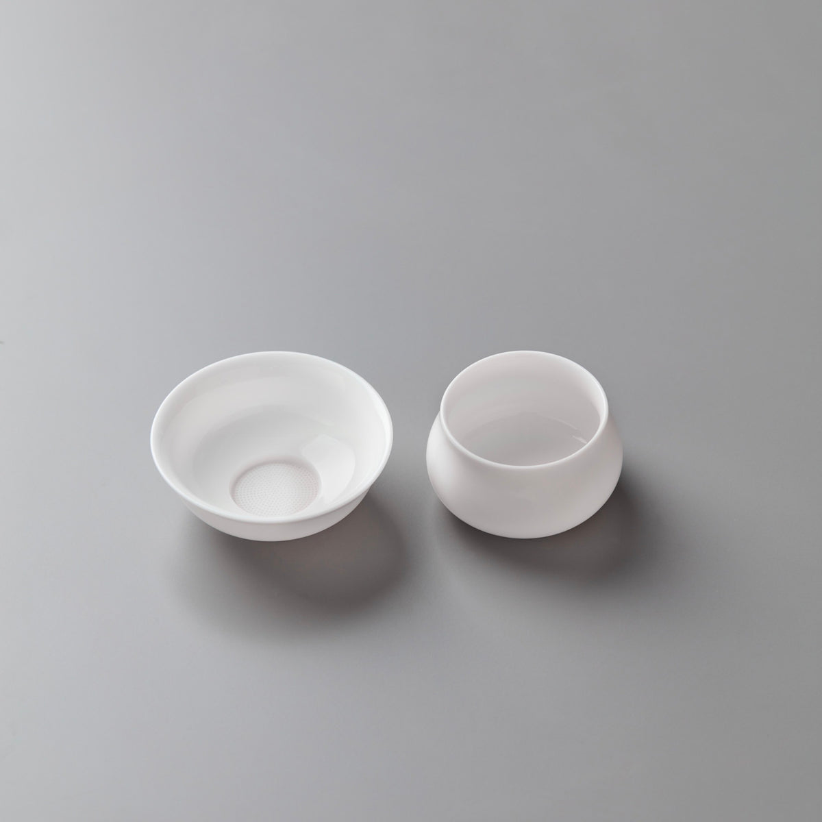 White porcelain tea filter and stand set with conical strainer and drip-catching base